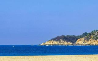 Beach sand blue water huge surfer waves Puerto Escondido Mexico. photo