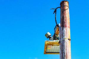 Old rusted lantern with blue sky background Holbox island Mexico. photo