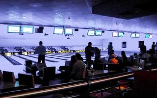 Teenagers and children play bowling throw bowling ball in Germany. photo