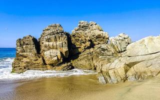 Big surfer waves and rocks at beach Puerto Escondido Mexico. photo