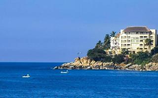 Big surfer waves and rocks at beach Puerto Escondido Mexico. photo