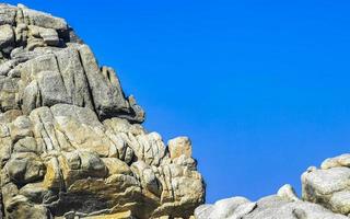 Big surfer waves and rocks at beach Puerto Escondido Mexico. photo