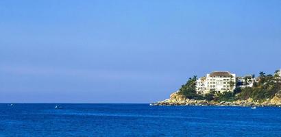 Big surfer waves and rocks at beach Puerto Escondido Mexico. photo