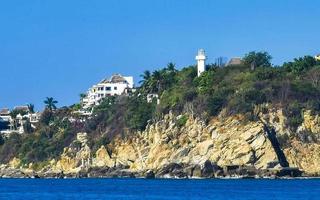 Big surfer waves and rocks at beach Puerto Escondido Mexico. photo