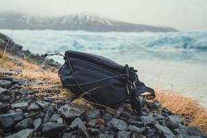 Close up camera bag on stones concept photo