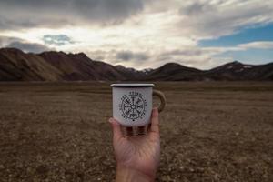 Close up person holding enamel mug concept photo