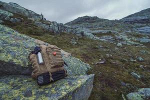 Close up large rucksack on rock at highland concept photo