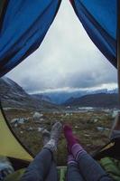 Close up female legs with socks at mountain camp concept photo