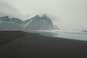 Wet surfline of black beach landscape photo