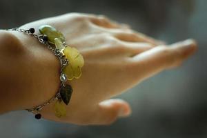 Close up bracelet with leaf shaped gems on wrist concept photo