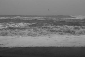 Sea beach on stormy day monochrome landscape photo