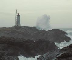 Lonely beacon and stormy sea landscape photo