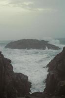 Foamy waves between cliffs landscape photo