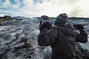 Climber with ice axe on snowy mountain scenic photography photo