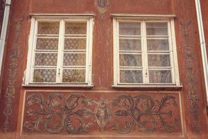 Amazing vintage ornament around building windows exterior photo