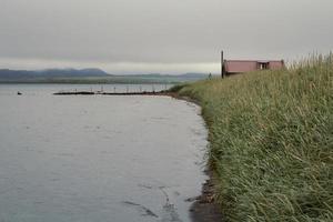 House and pier on lake bank landscape photo