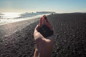 Close up female hand with sand concept photo