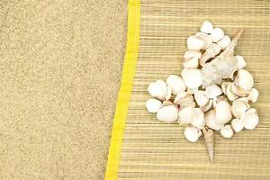 Heart made of white shells on straw lounger on sand with space for text. Valentine's day, travel, vacation. Copy space photo