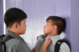 Soft focus of Southeast Asian boys are quarreling and fighting, fights between friends, misunderstandings and mutual forgiveness among friends concept. photo