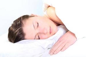 Woman sleeping on white sheets photo
