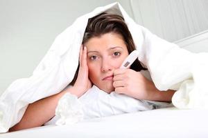 Woman sick in bed photo
