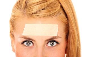 Woman with tape on forehead photo