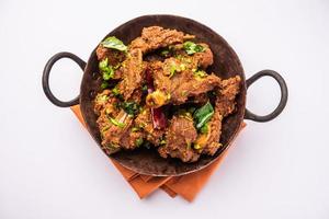 Sukha mutton or chicken, dry spicy Murgh or goat meat served in a plate or bowl photo