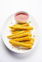 Crispy fried baby corn pakoda, pakora  or Baby corn fritters served with ketchup, Indian food photo
