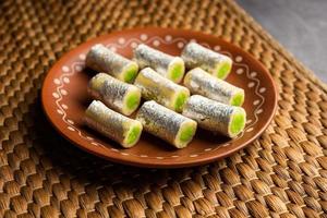 Kaju Pista Roll Or Cashew Pistachio Rolls Mithai or sigar, Indian sweet or dessert for festivals photo