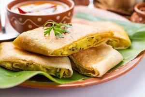 Cut Masala dosa or spring dosa is a South Indian meal served with sambhar and coconut chutney. photo