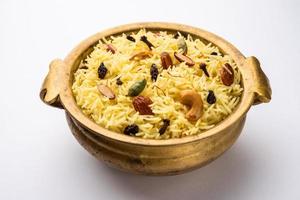 Kashmiri sweet modur pulao made of rice cooked with sugar, water flavored with Saffron and dry fruits photo