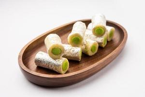 Kaju Pista Roll Or Cashew Pistachio Rolls Mithai or sigar, Indian sweet or dessert for festivals photo