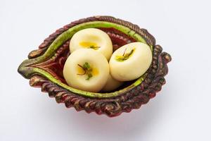 Sandesh or shondesh is a dessert, originating from the Bengal, India, created with milk and sugar photo