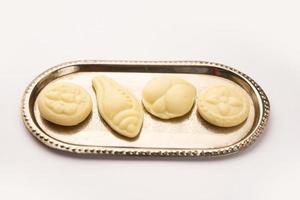 Sandesh or shondesh is a dessert, originating from the Bengal, India, created with milk and sugar photo