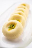 Sandesh or shondesh is a dessert, originating from the Bengal, India, created with milk and sugar photo