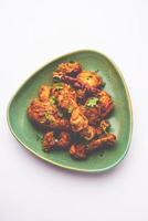 Sukha mutton or chicken, dry spicy Murgh or goat meat served in a plate or bowl photo