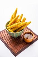 Crispy fried baby corn pakoda, pakora  or Baby corn fritters served with ketchup, Indian food photo