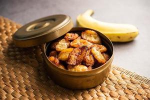 Deep fried ripe plantain slices or pake kele fried chips in a bowl photo