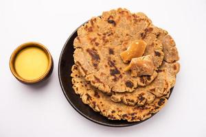 Sweet roti made out of rice flour, jaggery, and ghee. Gud ki roti. gur ki roti, jaggery Bhakri, meethi gud ki roti. Winter food. Copy space. photo