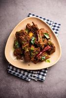 Sukha mutton or chicken, dry spicy Murgh or goat meat served in a plate or bowl photo