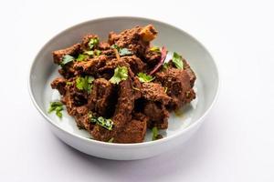 Sukha mutton or chicken, dry spicy Murgh or goat meat served in a plate or bowl photo