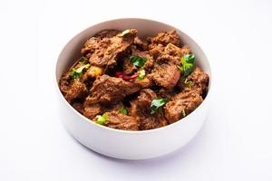 Sukha mutton or chicken, dry spicy Murgh or goat meat served in a plate or bowl photo