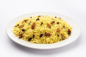 Kashmiri sweet modur pulao made of rice cooked with sugar, water flavored with Saffron and dry fruits photo