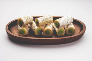 Kaju Pista Roll Or Cashew Pistachio Rolls Mithai or sigar, Indian sweet or dessert for festivals photo