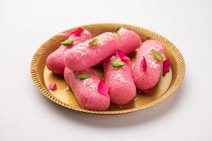 Pink Chumchum or rose flavoured chum chum or cham cham, indian and pakistani sweet photo