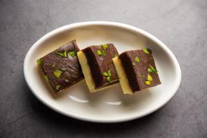 Choco Vanilla Patisa or chocolate mawa barfi or or two layered burfi, Indian sweet or dessert photo