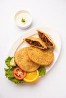Keema kachori is a popular indian or pakistani flacky, crispy and delicious snack with yummy qeema filling also known as Khasta Kheema Kachauri photo