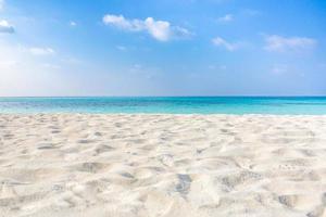 Sea sand sky concept. Closeup of sand on beach and blue summer sky, calmness and inspiration nature concept photo