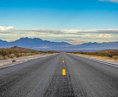 Panoramic image of a lonely, seemingly endless road in the desert photo