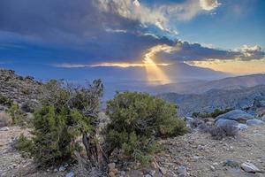 Image of a spectacular weather scene with impressive sun rays through a hole in the clouds photo